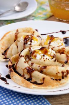 Pancake folded in the form of a snail cottage cheese with chocolate