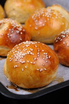 Buns with sesame in a pan just out of the oven