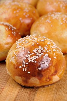 Buns with sesame seeds on table closeup