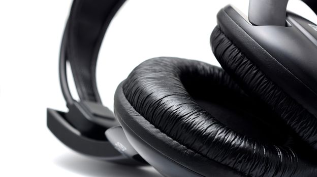 Black headphones on the white background. Closeup shot.