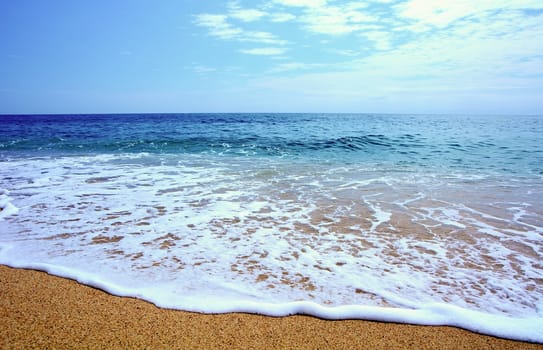 Sea waves on the beach. Yellow sand with waves. 