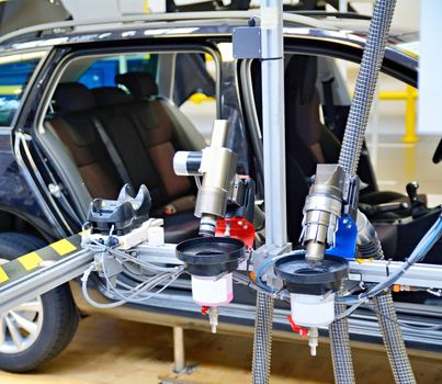 Closeup of the automated machine at assembly line in car factory.