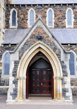 Entry into the unknown church with wooden doors.