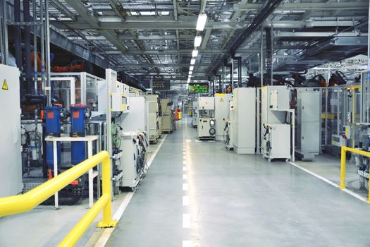 Industrial interior of the factory with computers and robots.