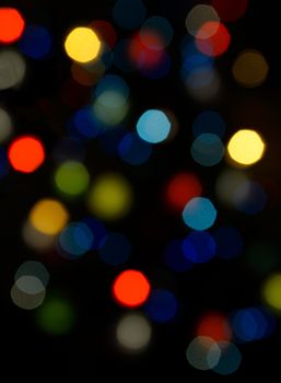 Color blurred bokeh lights. Useful for Christmas background or greeting cards.