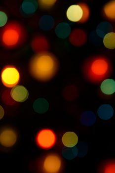 Color blurred bokeh lights. Useful for Christmas background or greeting cards.