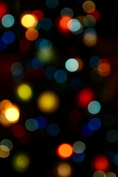 Color blurred bokeh lights. Useful for Christmas background or greeting cards.