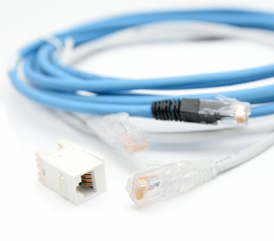 Blue and gray ethernet Cat5e cables with RJ45 cable extender on a white background.