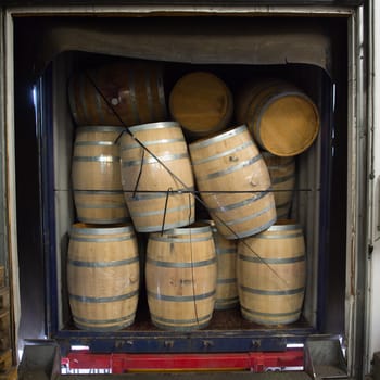 Wine barrels stacked in Truck ,Loading dock, Bordeaux Vineyard, France