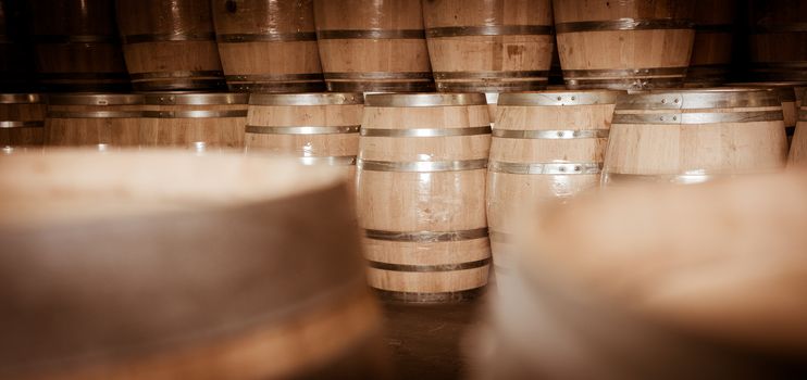 Wine barrels stacked in cellar, Bordeaux Vineyard, France