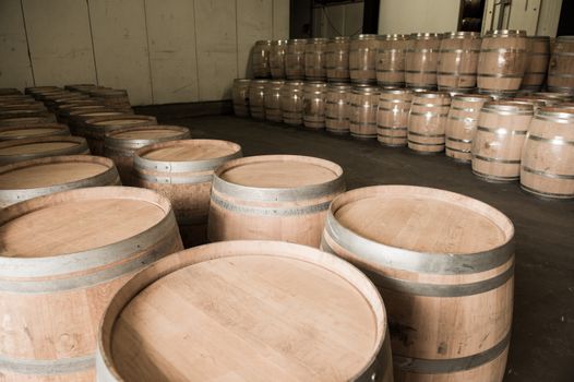 Wine barrels stacked in cellar, Bordeaux Vineyard, France