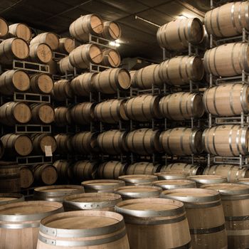 Wine barrels stacked in cellar, Bordeaux Vineyard, France