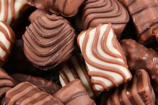 An assortment of fine chocolates in white, dark, and milk chocolate