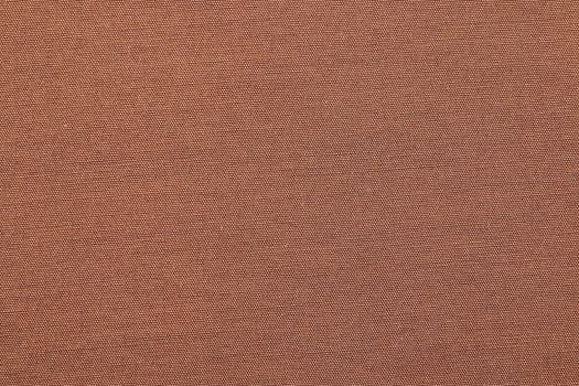 The closeup brown cotton background with textile texture