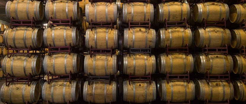 Wine barrels stacked in cellar, Bordeaux Vineyard, France