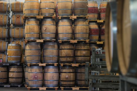 Wine barrels stacked in cellar, Bordeaux Vineyard, France