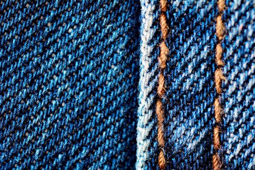 Blue jeans macro. Jeans fabric texture. Seam on jeans.