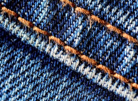 Blue jeans macro. Jeans fabric texture. Seam on jeans.