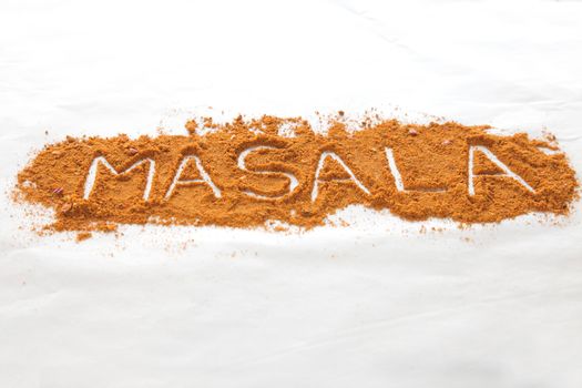 Masala text written in font of spices in perspective