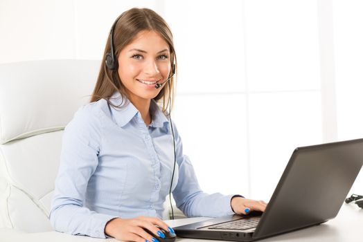 Beautiful Businesswoman with Headphones working in the office.