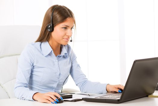 Beautiful Businesswoman with Headphones working in the office.