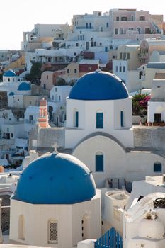 Blue domes and their bell tower in Oia. Santorini