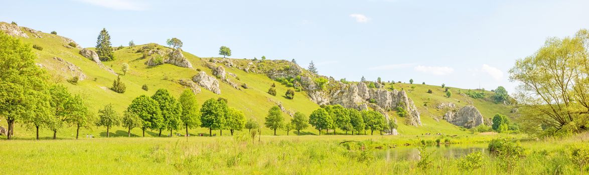 Panorama of valley Eselsburger Tal near river Brenz - jewel of the swabian alps (Schwaebische Alb), green meadow / grassland in front