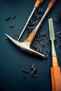 Traditional tools of upholsterer on a table closeup