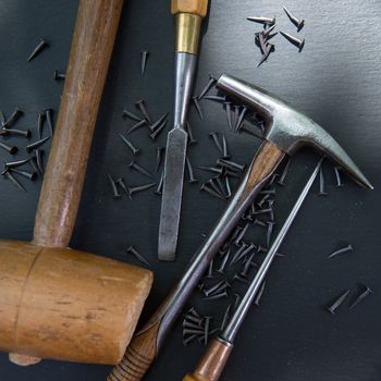 Traditional tools of upholsterer on a table closeup