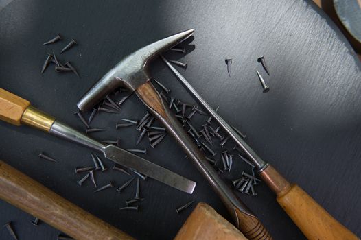 Traditional tools of upholsterer on a table closeup