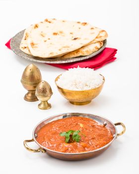 East Indian meal consisting of butter chicken, rice and nan bread.