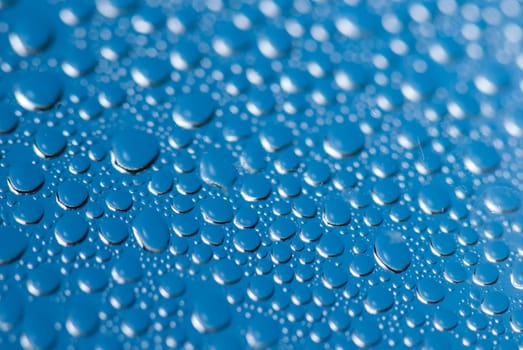 close-up of water drops on the blue background.