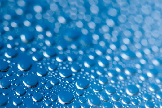 close-up of water drops on the blue background.