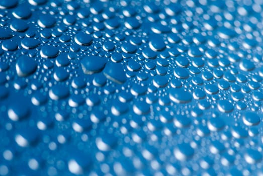 close-up of water drops on the blue background.