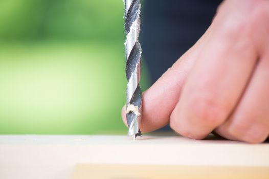 Close up of drill in wood outdoor