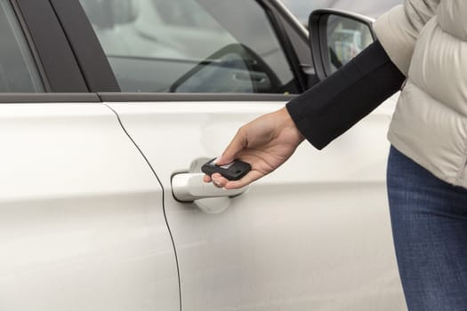 the hand of the girl keeps the handle door white passenger car