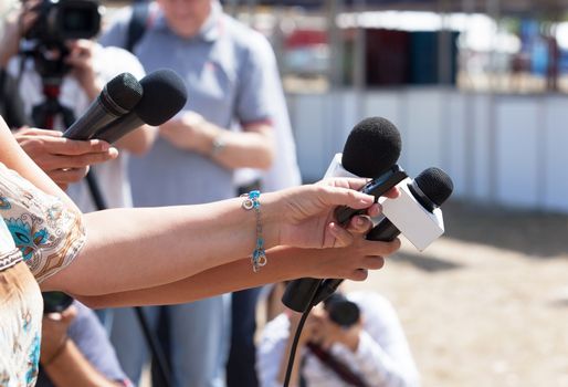 Press conference. Microphones. 