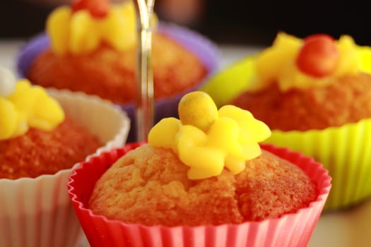 Vanilla cupcakes with lemon frosting on a cake stand