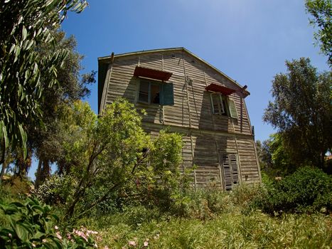 Old weathered abandoned western colonial style wooden house shed