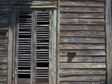 Details of an old weathered abandoned western colonial style wooden house shed