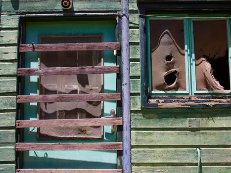 Details of an old weathered abandoned western colonial style wooden house shed