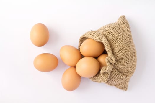 Brown eggs in canvas sack isolated on a white background 