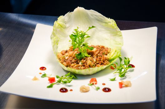 Thai basil pork stir fry (stir-fried pork and basil) in cabbage. Thai cuisine.