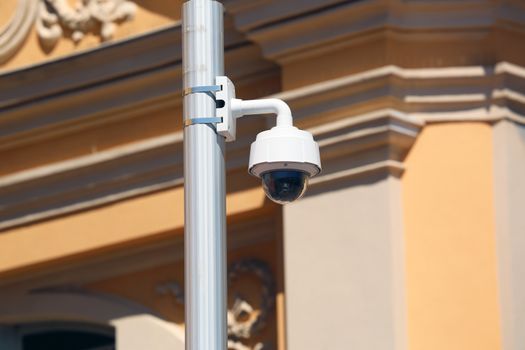 Dome Type Outdoor CCTV Camera on Street Lamp in Nice, Architecture of a Church in the Background