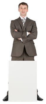 Businessman with crossed arms behind blank paper isolated on white background