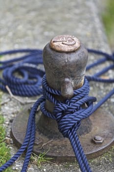 Boat anchored pole with blue rope, England