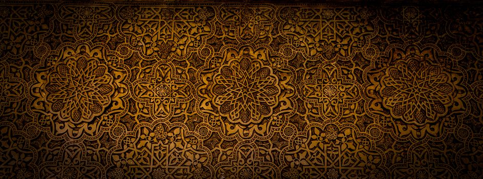 Wall detail of Alhambra UNESCO site in Granada - South of Spain. 600 years old arabic characters.