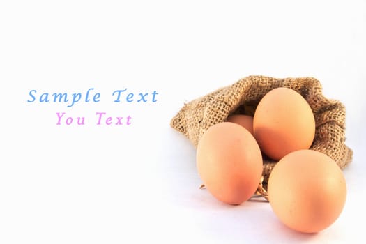 Brown eggs in canvas sack isolated on a white background 