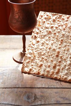 Seder concept. Still life with matzoh near metal wineglass