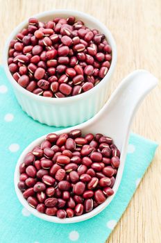 azuki beans or red beans in white cup on tablecloth.